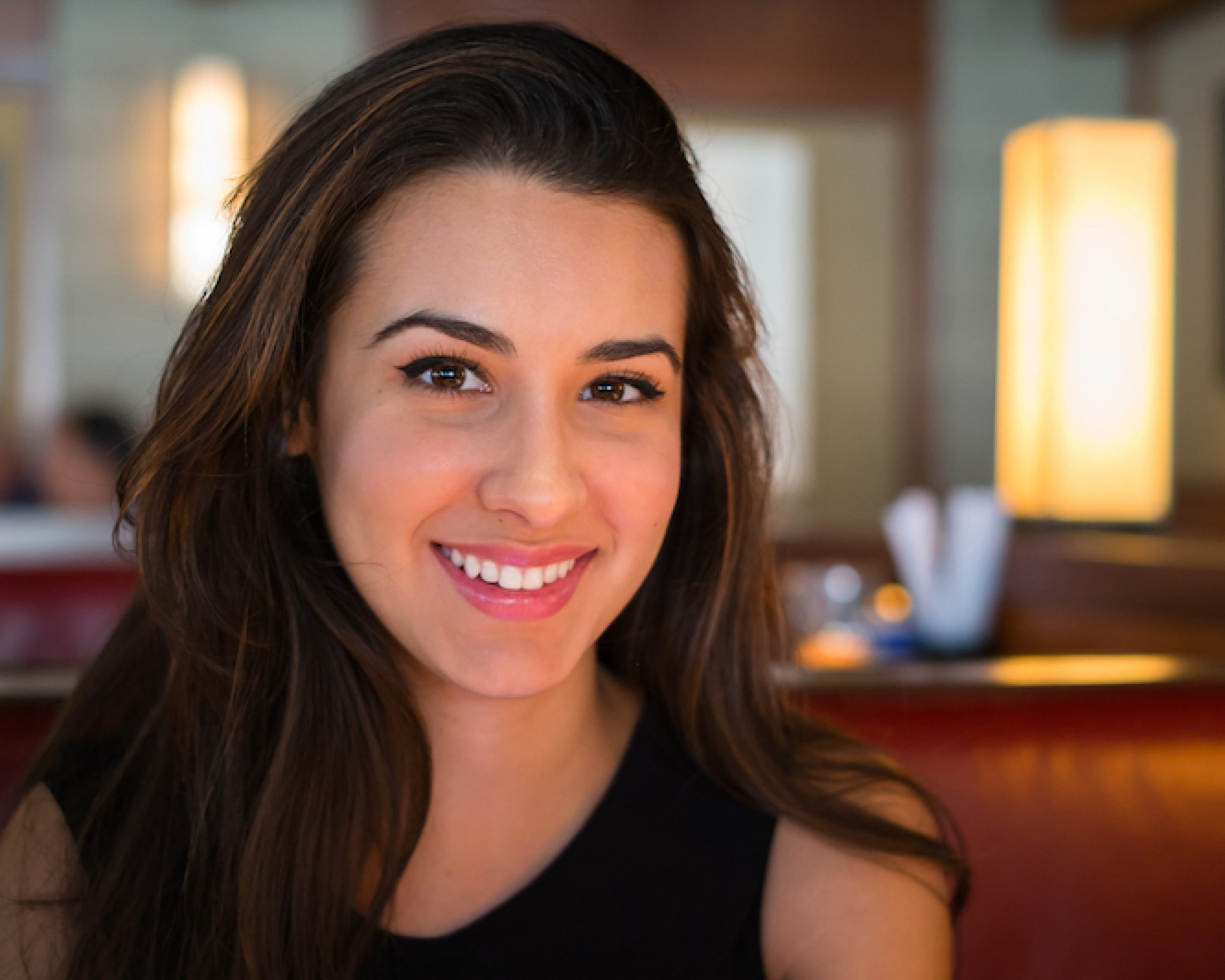 Beautiful multicultural young woman portrait in a restaurant setting.