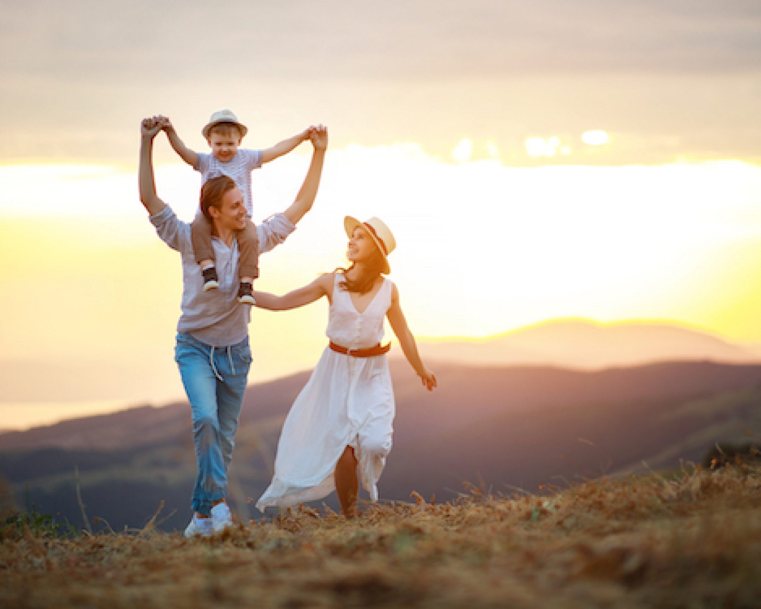 Happy family father of mother and child son  on nature at sunset